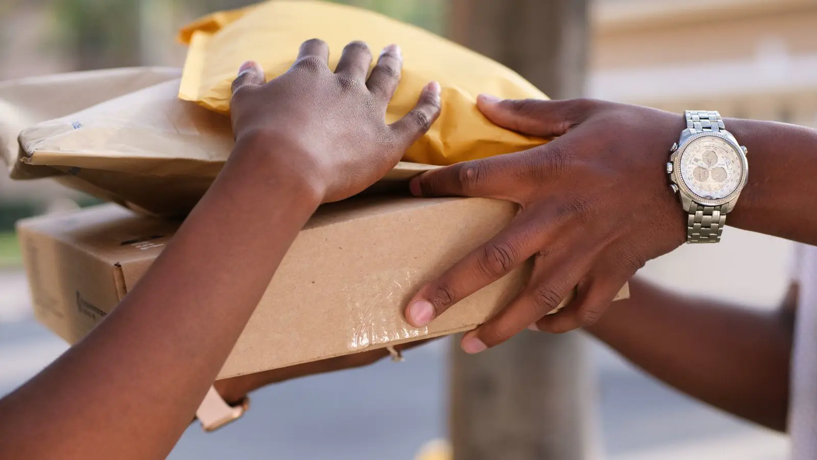 Hands passing a packed parcel