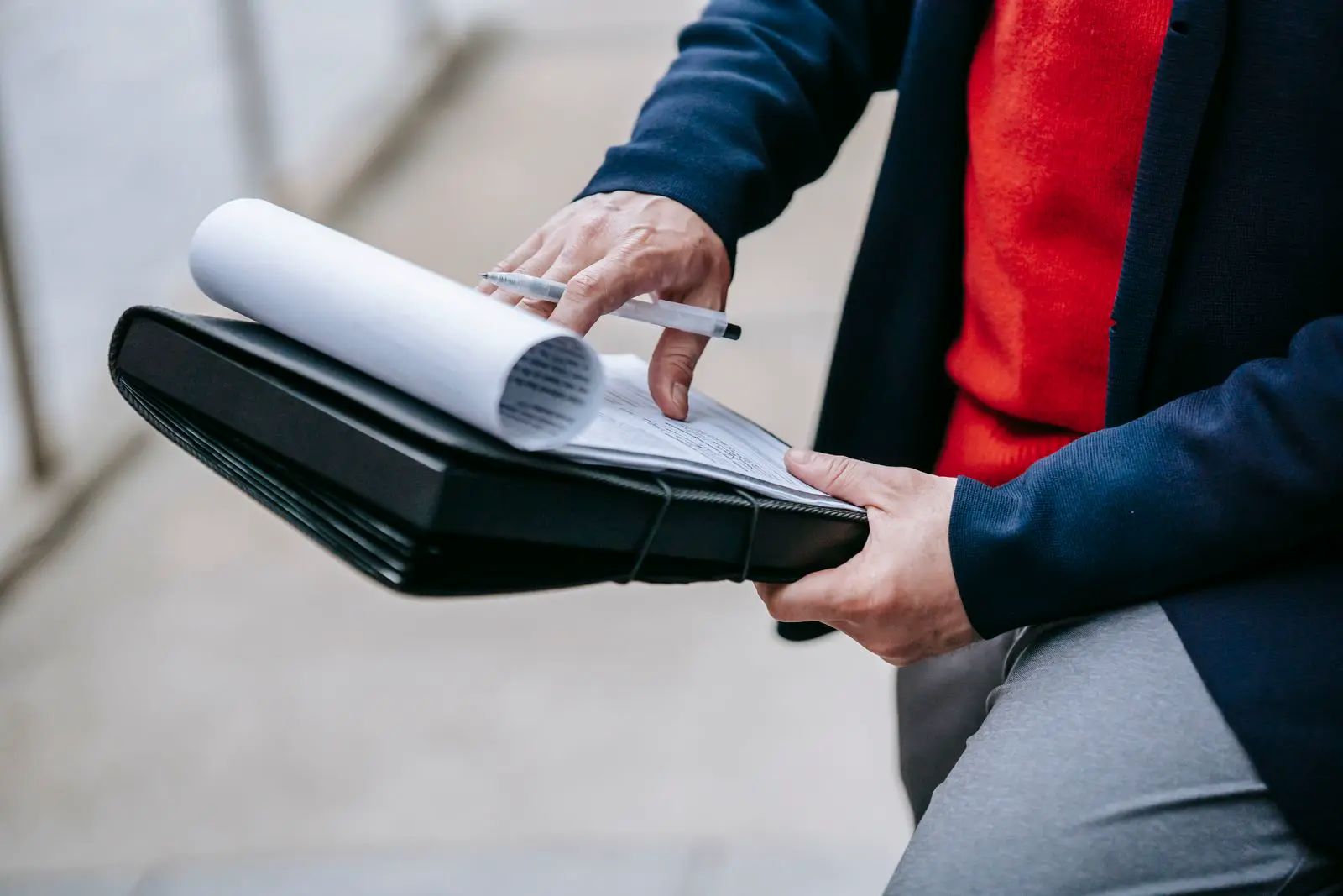 Clearing agent checking shipment documents on a clipboard